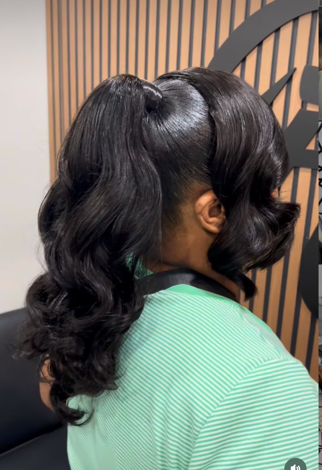 Sleek low ponytail with soft waves